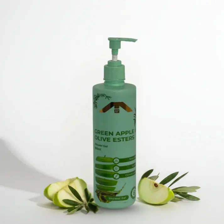 “All People Green Apple & Olive Esters Shower Gel bottle with pump, placed with sliced green apples and olive leaves on a clean white background.”