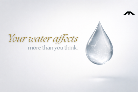 Minimalist banner showing a clear water droplet with subtle internal stress lines on a light background, symbolizing how tap water can quietly affect skin health.