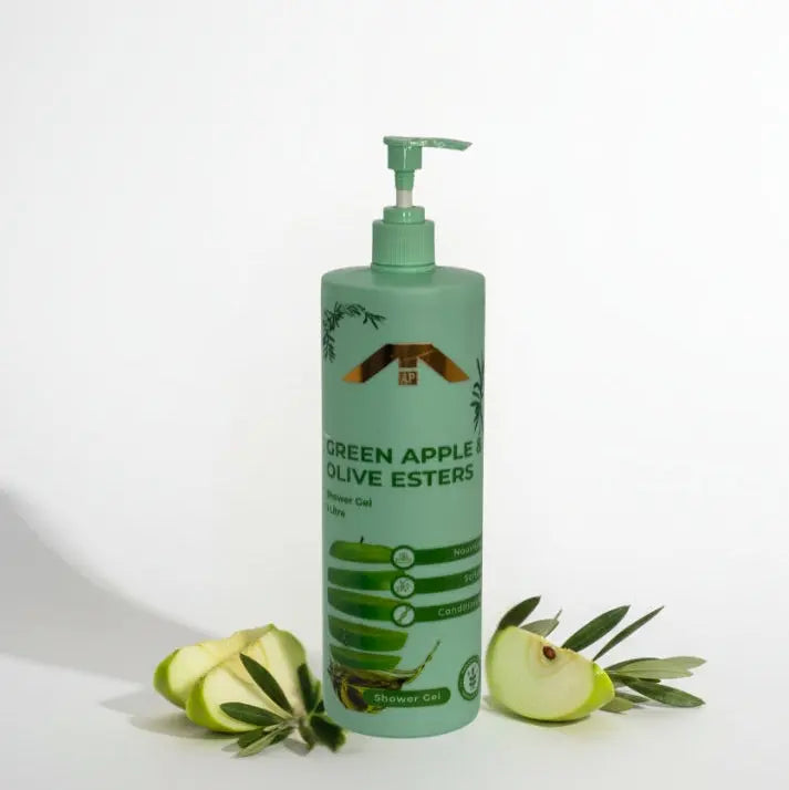 “All People Green Apple & Olive Esters Shower Gel bottle with pump, standing with sliced green apples and olive branches on a white backdrop.”