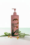Pink bottle of aloe vera lotion with pump on a white background