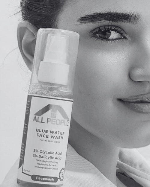 Bottle of All People Blue Water Face Wash held by a person