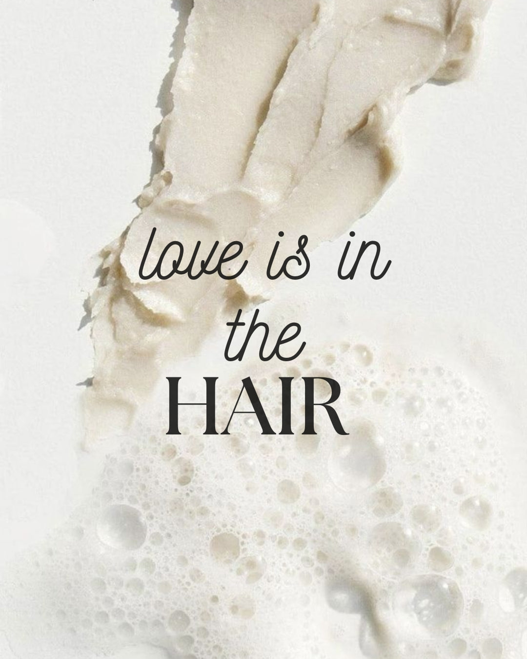 Close-up of hair with text 'love is in the HAIR' on a light background