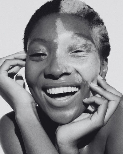 Black and white portrait of a person with a smile on their face